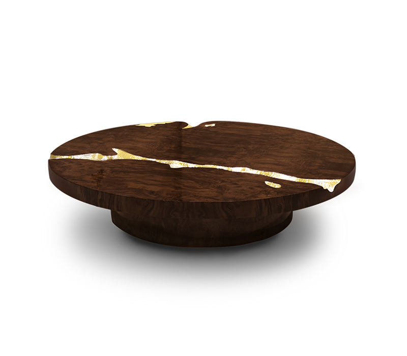 The modern coffee table is built from mahogany wood and features an exquisite polished brass surface detail