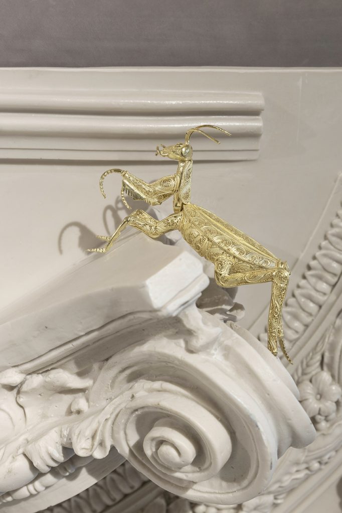 craftmanship - mantis in gold filigree on top of a resin structure