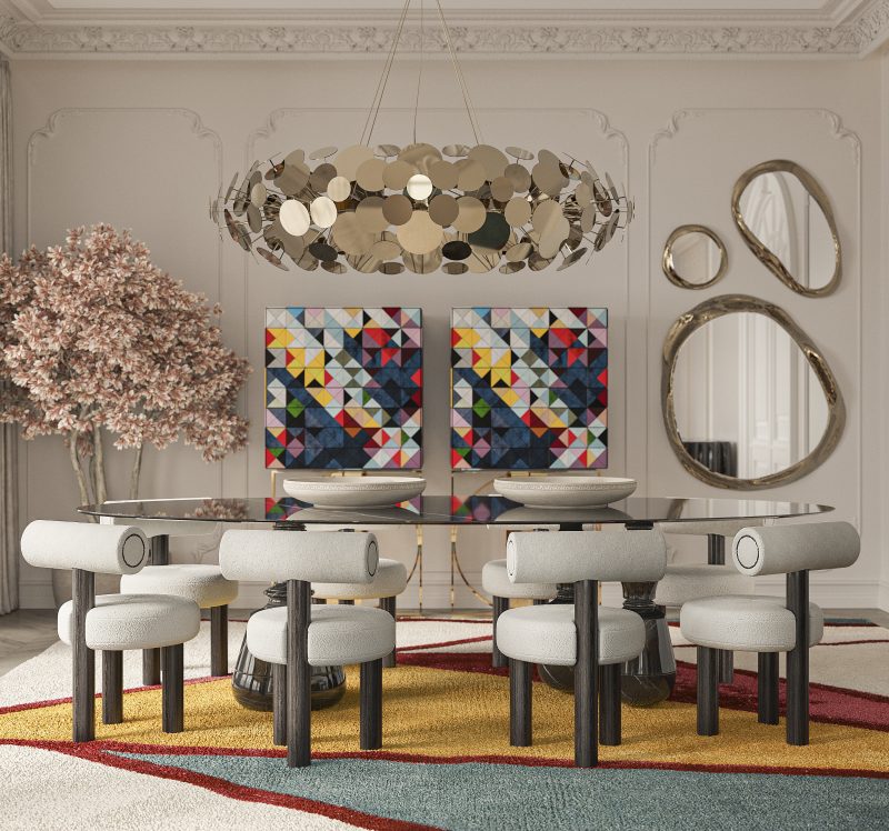dining room wth black marble dining tale, nude dining chairs with dark wood features two multicolored cabinets, a statement mirror wall and a gold suspension lamp