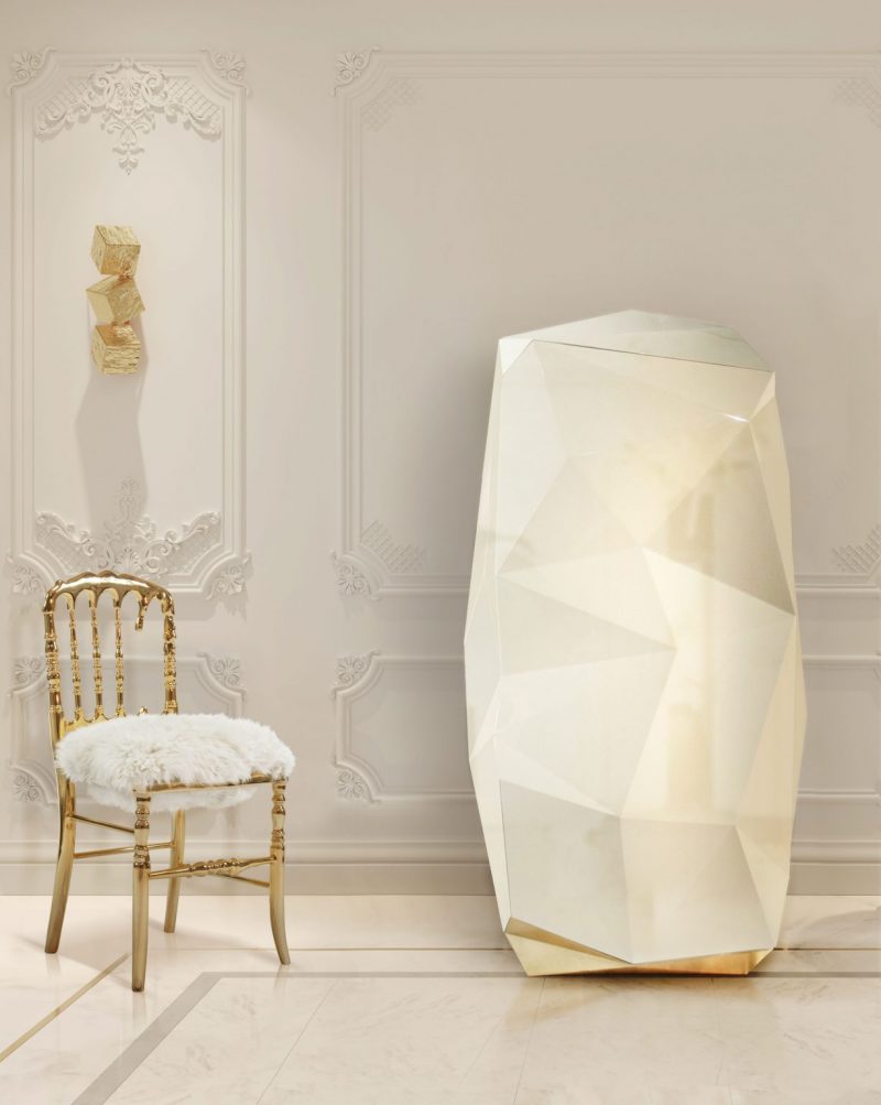 dining chairs - gold chair and white fur, white walls, gold wall lamp, cream safe