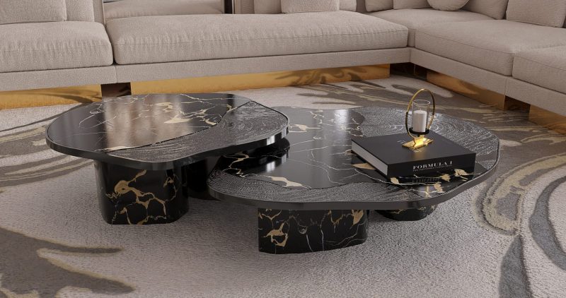 Ophelia Center Table - black marble and gold center table, a book, a rug and a cream and gold sofa