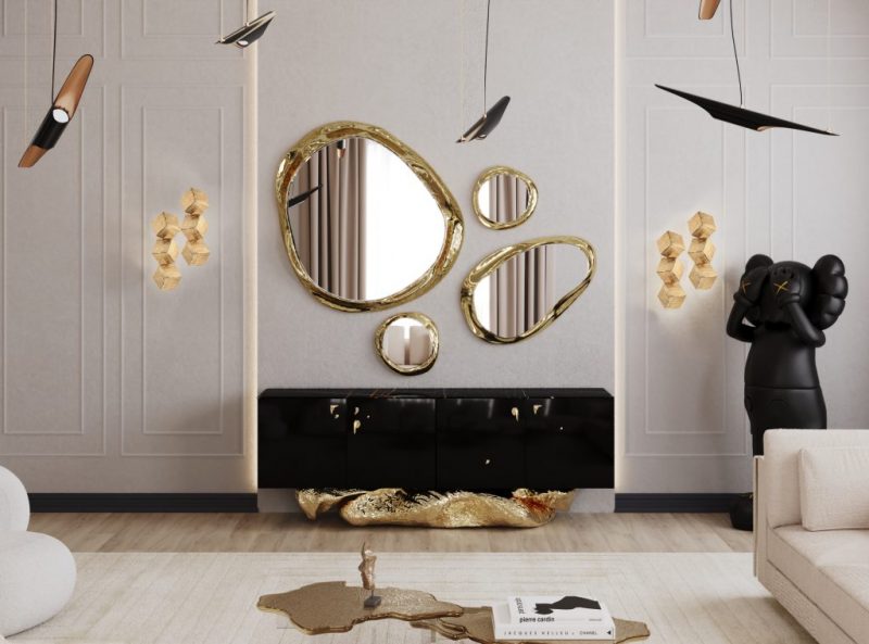 texas interior design-  living room with round gold mirrors, gold wall lamps, black hanging lamp, black sideboard and gold base, gold coffee table with decorative items