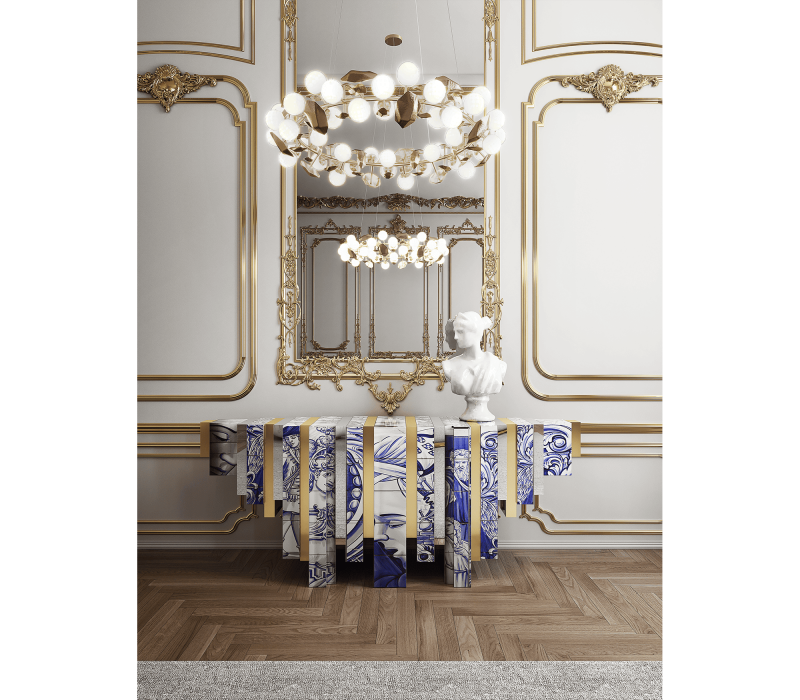 The Heritage Console stands out for its designs inspired by Portuguese azulejos and its handcrafted details, which lend character and elegance to the room. and a white and gold wall with a chandelier